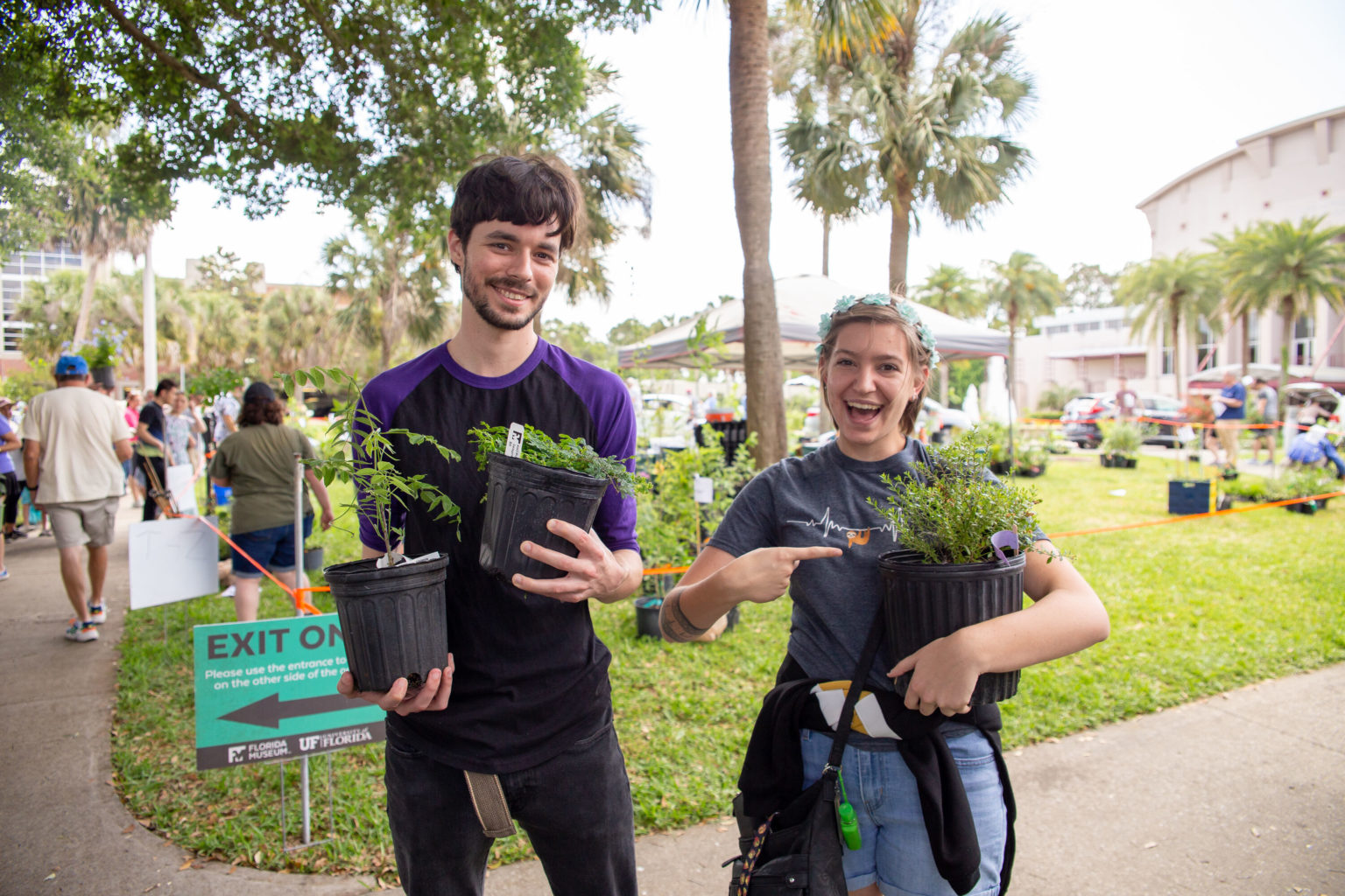 Happy young people with their new plant purchases